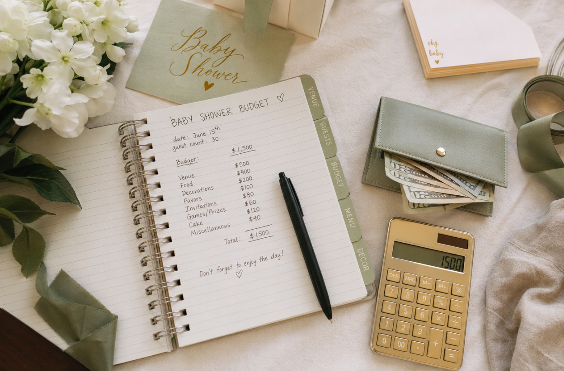 baby shower budget planning flat lay with notebook pen wallet calculator and green decor