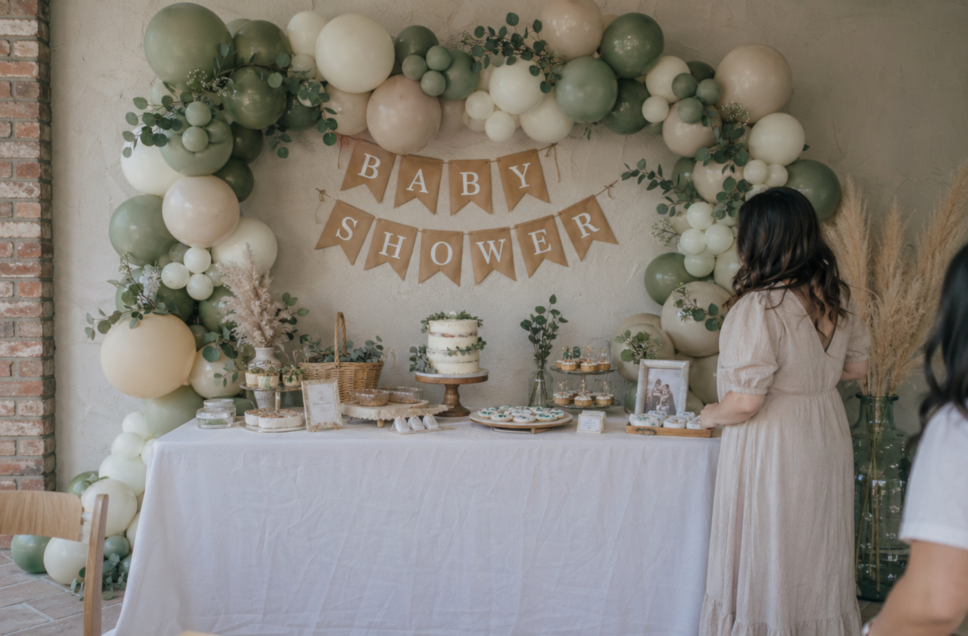 DIY baby shower decor with balloon garland kit eucalyptus kraft paper banner pampas grass sage green cream